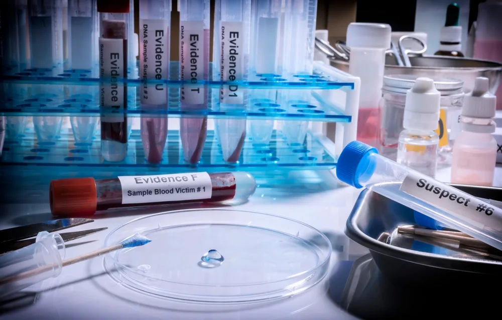 Labelled evidence tubes and blood samples on a laboratory bench