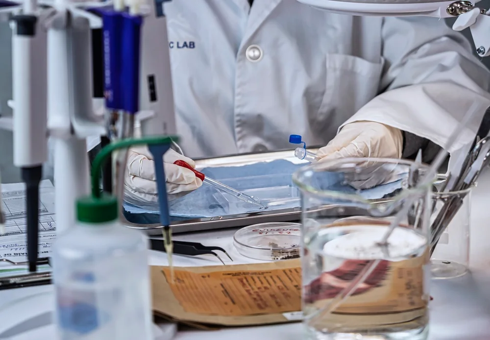 Pipettes and sample containers on a forensic laboratory bench
