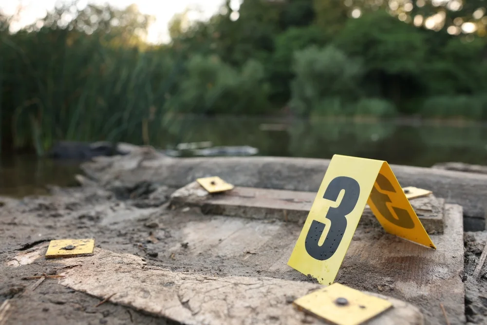Numbered evidence markers placed on the ground at an outdoor scene