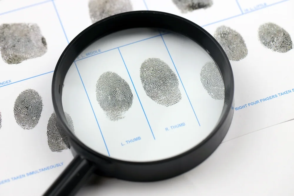 Magnifying glass over a ten-print fingerprint card