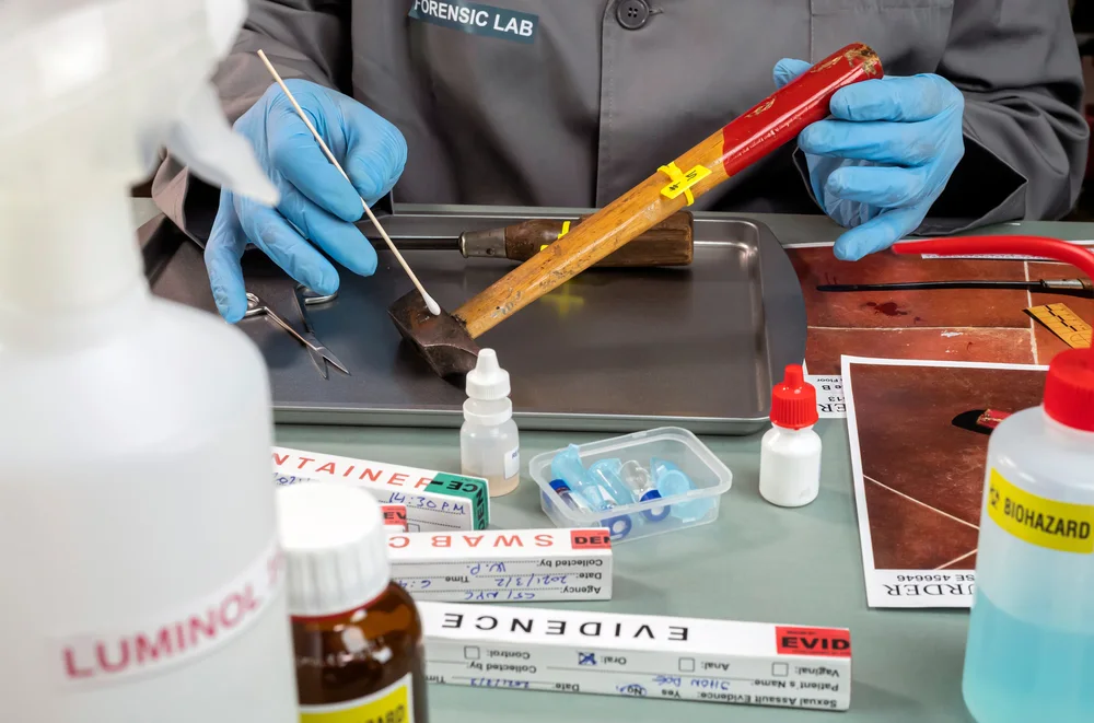 Forensic bench with luminol spray, swab kits and evidence packaging