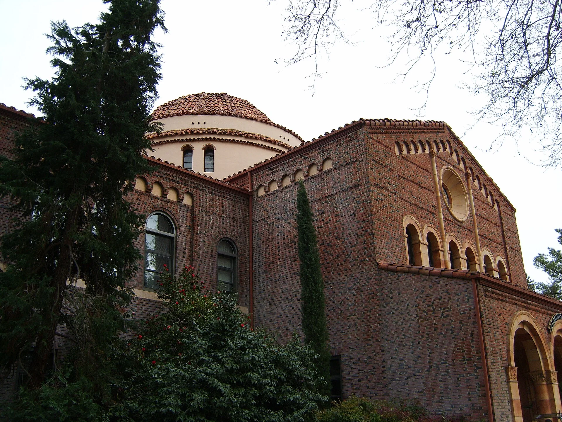 The brick administration building at California State University, Chico, seen through trees