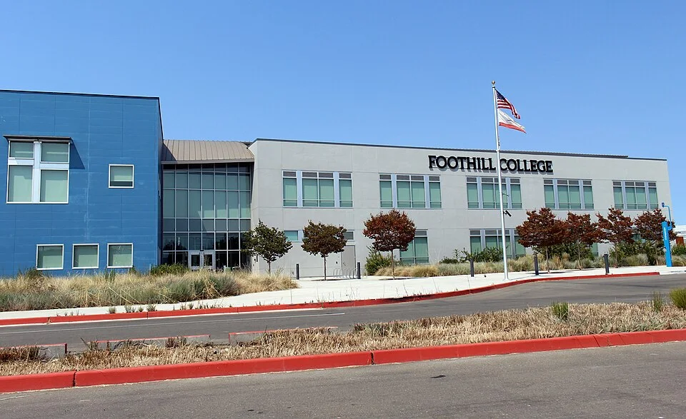 A blue and white Foothill College building with the college name mounted on its facade