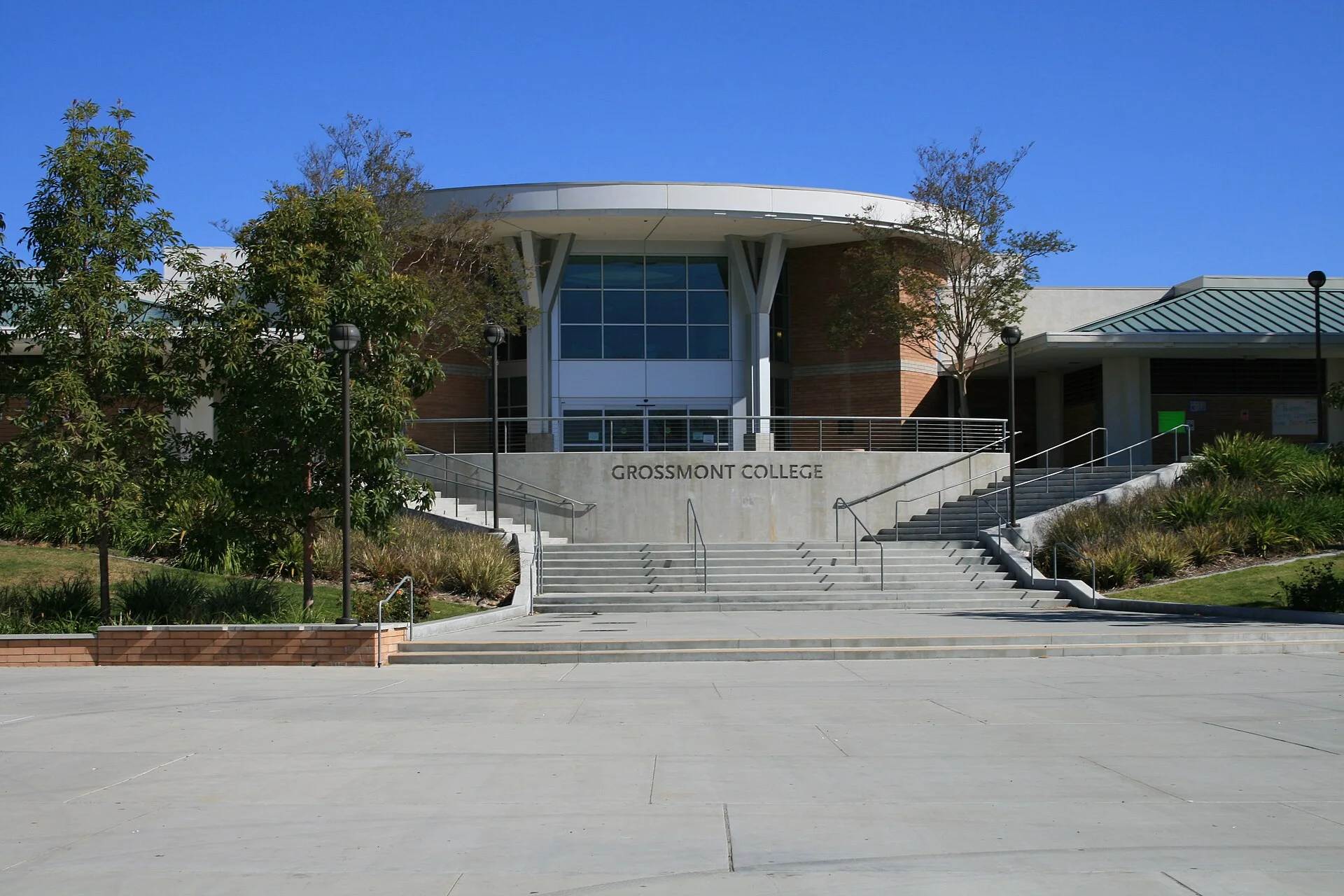 A curved-roofed building at Grossmont College above a wide flight of campus steps