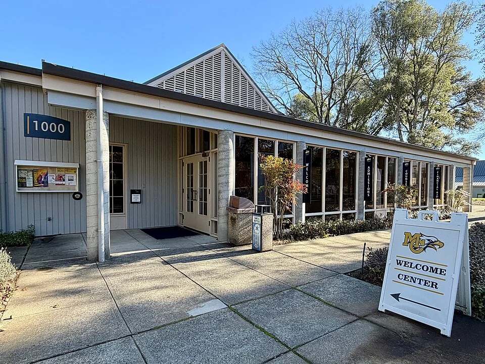 The welcome centre building at Mendocino College with its covered walkway and signage