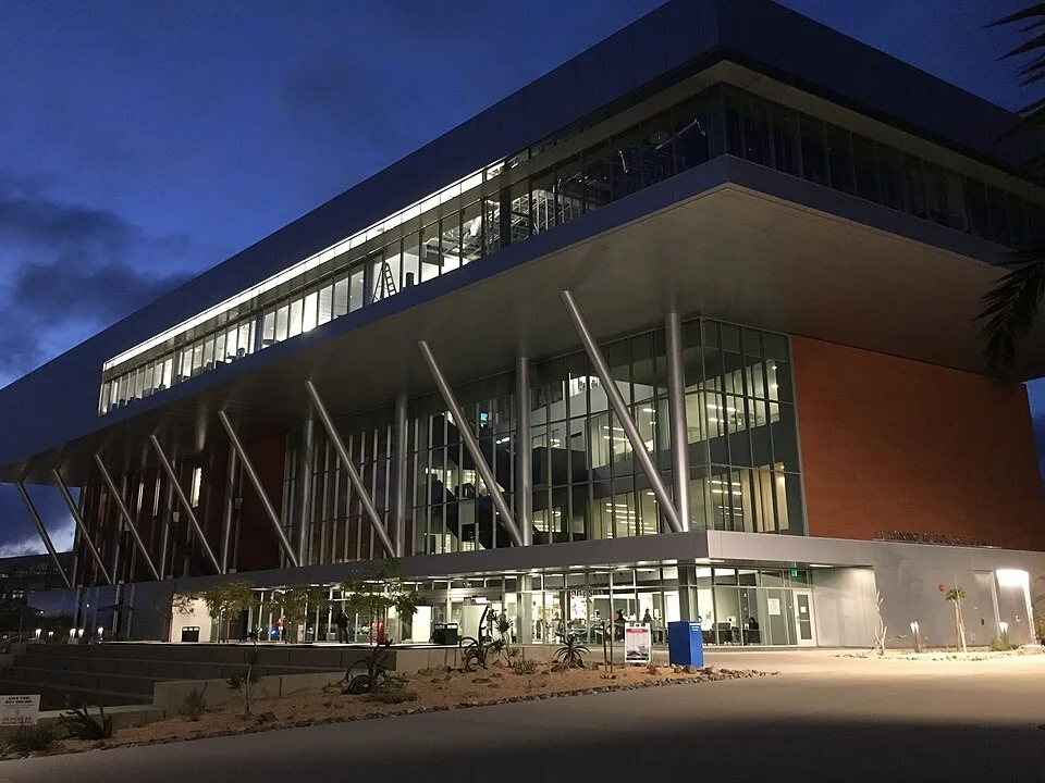 The modern library building at Palomar College lit at dusk
