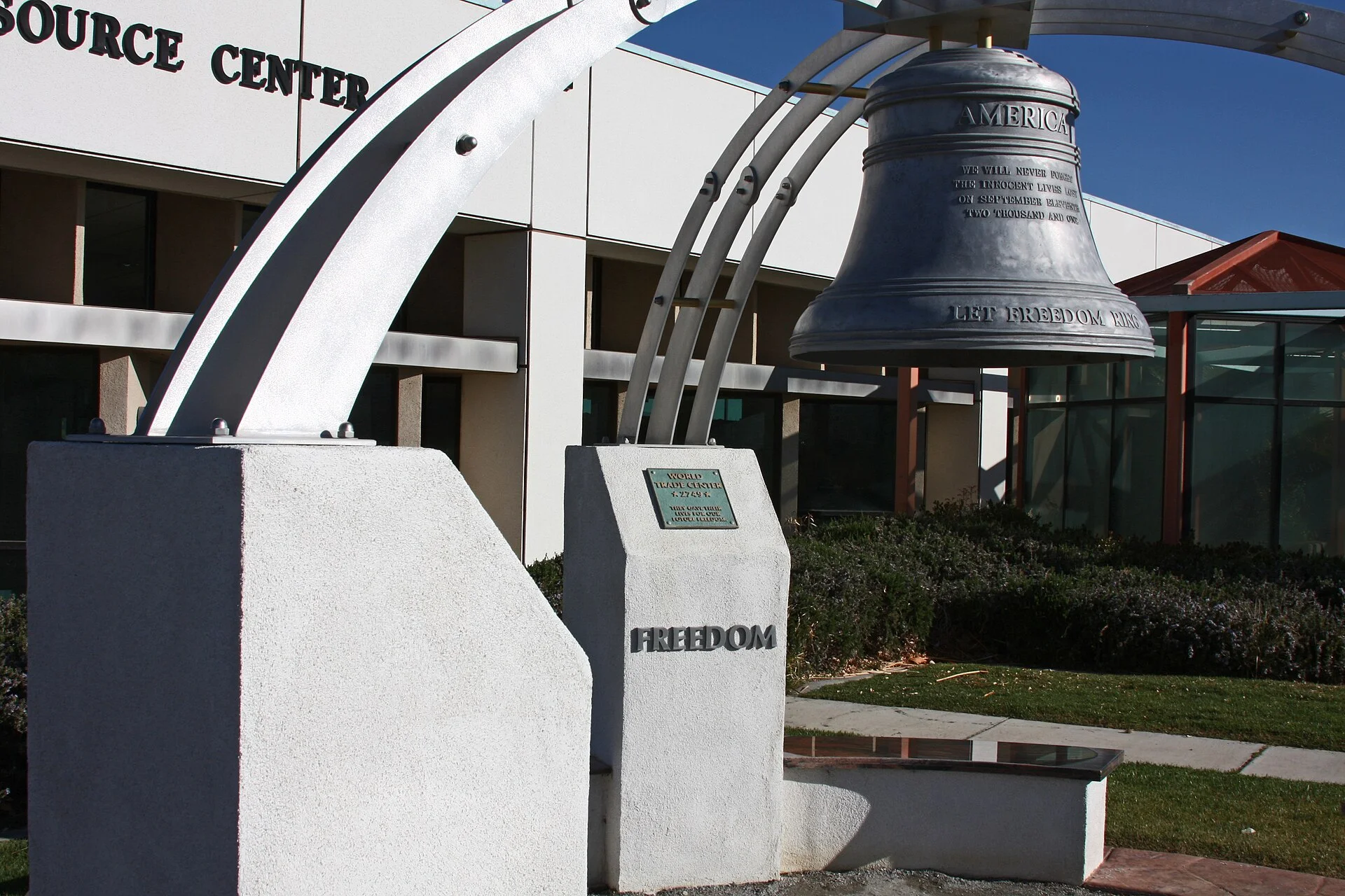 A bell monument outside the resource center building at Victor Valley College