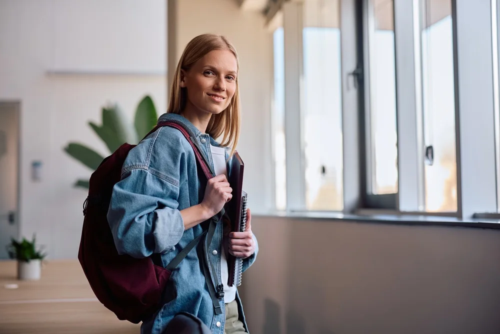 Student with a backpack in a campus building
